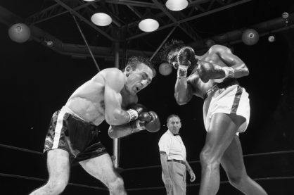 Two boxers in the ring in black and white.